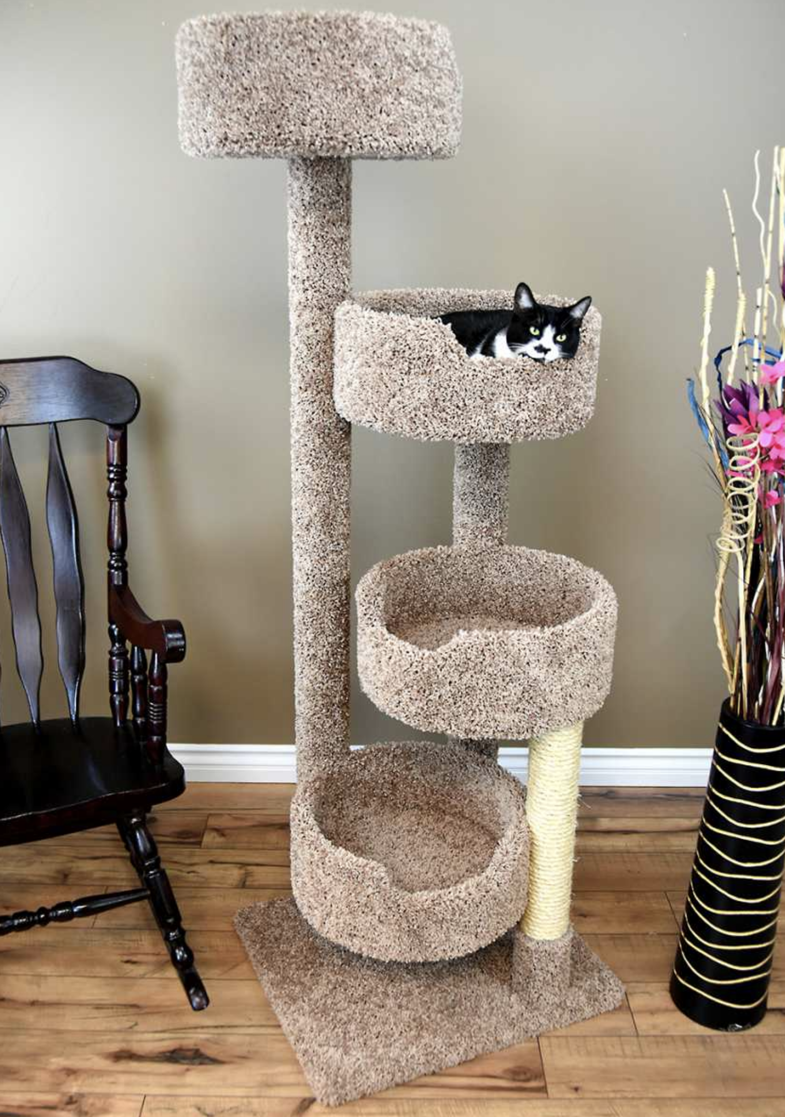 Cats climbing and lounging on different levels of a custom cat tree, reducing boredom and anxiety.